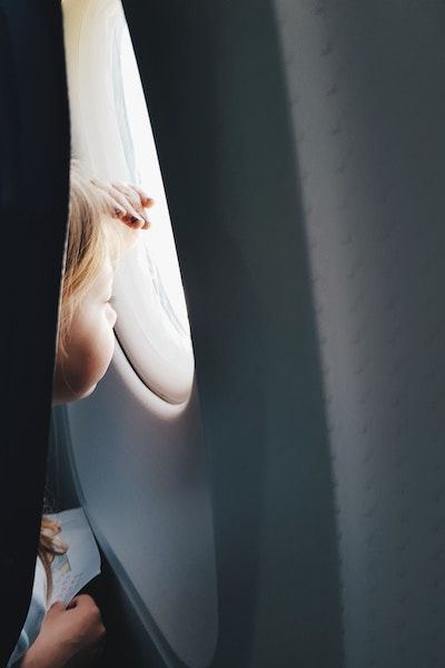 Picture of a child looking out of an airplane window